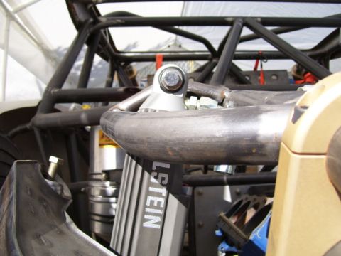 1968 Ford Mustang - Close-up of an upper coilover shock mount on a tube-chassis race vehicle, showing a Bilstein-branded shock body bolted through a bracket wi…