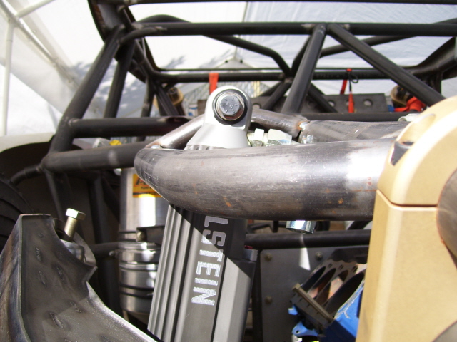 Upper Bilstein coilover shock mount bolted to tube chassis crossmember on race car