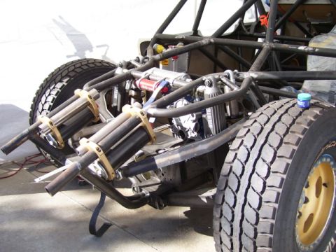 1968 Ford Mustang - Close-up view of a trophy truck's rear suspension system, dual shock absorbers and coilover units.