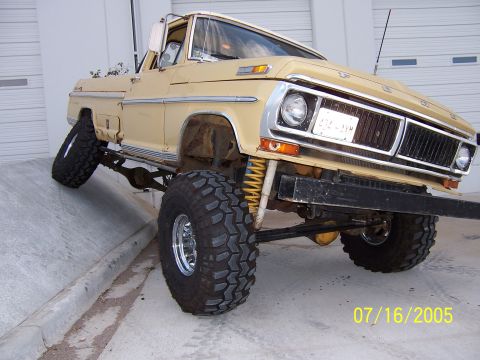 1994 Ford Bronco - This lifted Ford truck, likely from the early 1970s, is shown in a 3/4 front view with its front wheels on an incline.