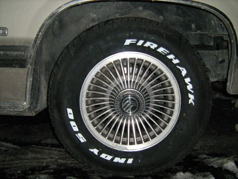 1988 Mercury Grand Marquis - A close-up view of a Firehawk Indy 500 tire mounted on a Mercury vehicle's wheel.