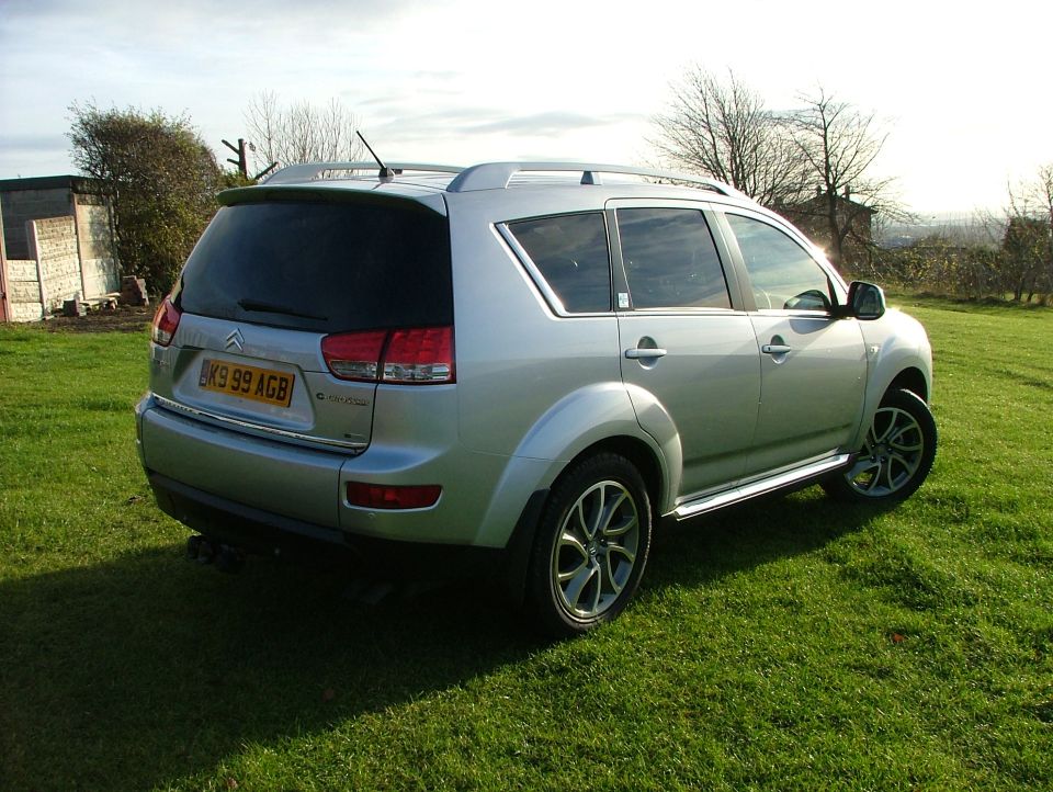 Silver Citroen C-Crosser SUV rear three-quarter view on grass