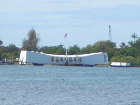1985 Ford Bronco - The USS Arizona Memorial stands as a solemn tribute over the waters, with lush greenery in the background.