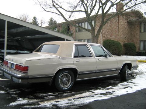 1988 Mercury Grand Marquis - A 1988 Mercury Grand Marquis is seen parked in a lot with snow on the ground.
