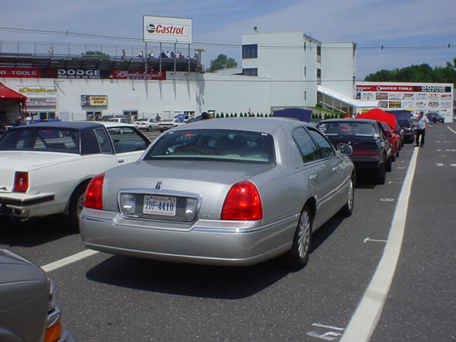 Silver 1994 Lincoln Town Car parked in a lot with other cars. License plate JDF-4410