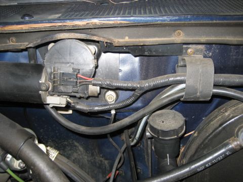 1981 Ford Bronco - The windshield wiper motor assembly is visible, along with various hoses and wiring connected to it.