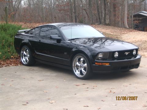 2007 Ford Mustang - Black 2007 Ford Mustang GT shows off its chrome wheels and front grille.