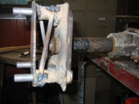 2001 Ford F-150 - Close-up of a rusty, welded metal bracket attached to a shaft.