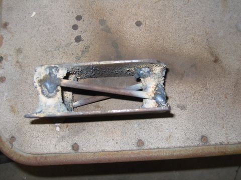 2001 Ford F-150 - A close-up view of a crudely welded metal component, possibly a bracket or frame piece, showing signs of repair and use.