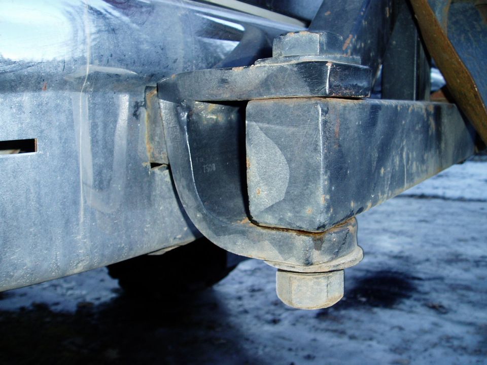 Close-up of a trailer hitch mount with a large bolt