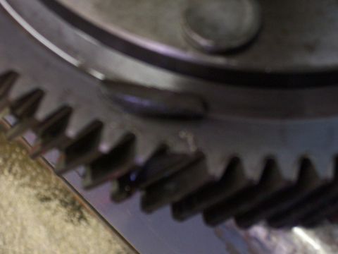 1989 Ford Probe - A close-up view of a mechanical gear and a surrounding metal ring, with a website logo visible.