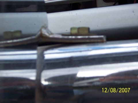 1996 Ford Bronco - Close-up view of a chrome grille guard, showing mounting hardware and reflective surface.
