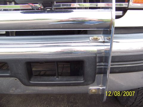 1996 Ford Bronco - Close-up of a vehicle's front end, showing a chrome grille guard and bumper details.