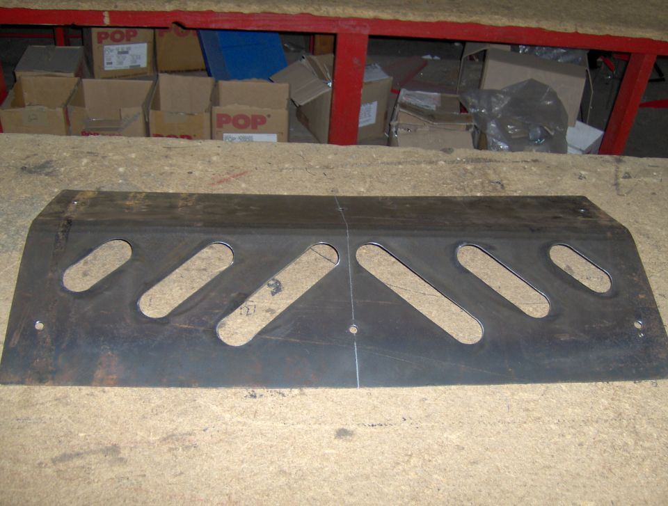 Metal skid plate with diagonal slots and mounting holes