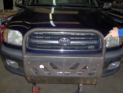 1978 Ford Bronco - A dark blue Toyota Tundra is shown from the front, equipped with a custom-fabricated brush guard over its grille.