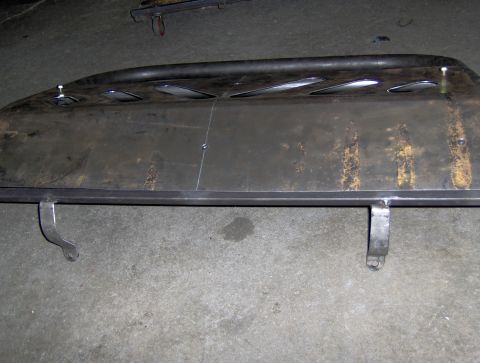 1978 Ford Bronco - A close-up view of a metal brush guard, likely for an off-road vehicle, resting on a concrete floor.