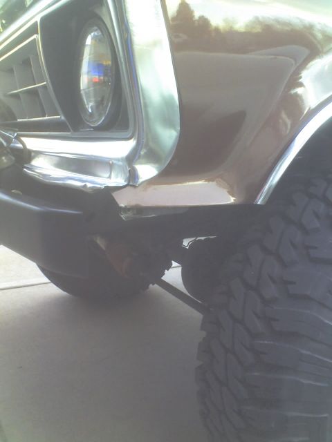 1979 Ford Bronco - Close-up of the front fender and tire of a vintage SUV, highlighting its build.