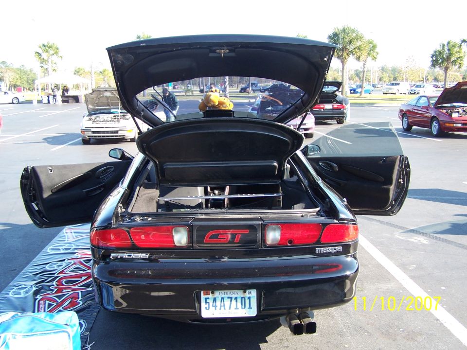 Black 1995 Ford Probe GT rear view with open trunk and doors