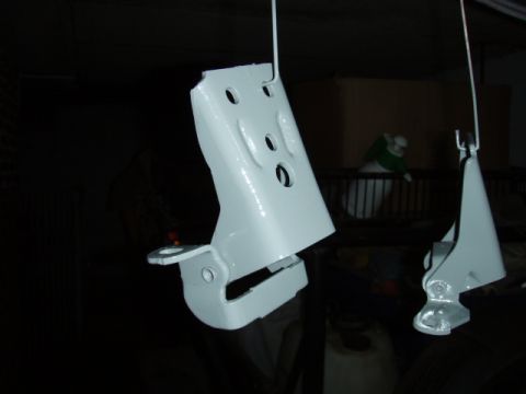 1995 Ford F-150 - Two freshly painted door hinges are shown hanging, ready for installation.