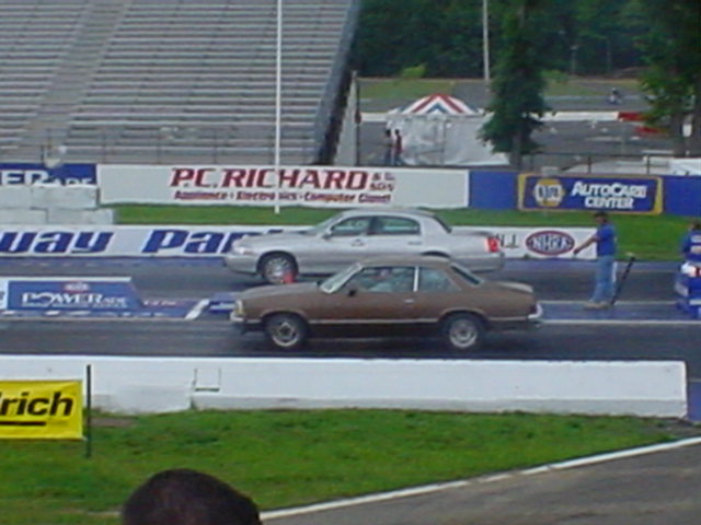 Silver 1994 Lincoln Town Car racing on a drag strip