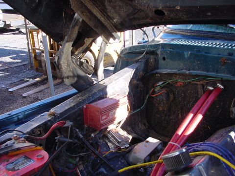 1979 Ford Bronco - Close-up of a vehicle's engine bay, focusing on the ignition system and battery.