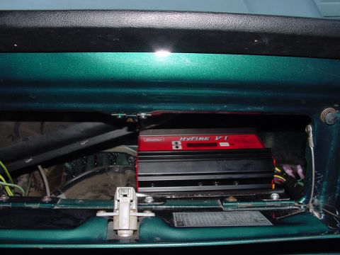 1979 Ford Bronco - A red HyFire VI ignition module is visible inside a green vehicle's interior panel.