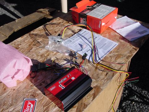 1979 Ford Bronco - A Hyfire VI ignition system is laid out with its wiring harness and instruction manual on a wooden surface.