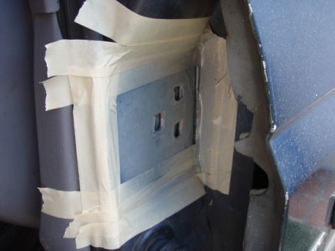1995 Ford F-150 - Close-up of a vehicle's door jamb, showing masked-off areas around the hinge mounting points.