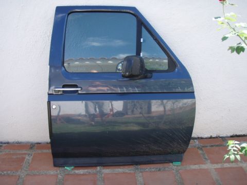 1995 Ford F-150 - A blue truck door, likely from a Ford F-150, is shown with its chrome handle and black side mirror.
