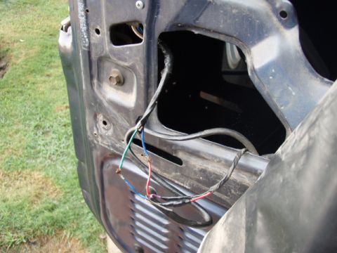 1995 Ford F-150 - Close-up view of the door jamb wiring on a 1995 Ford F-150, likely related to door hinge repairs.
