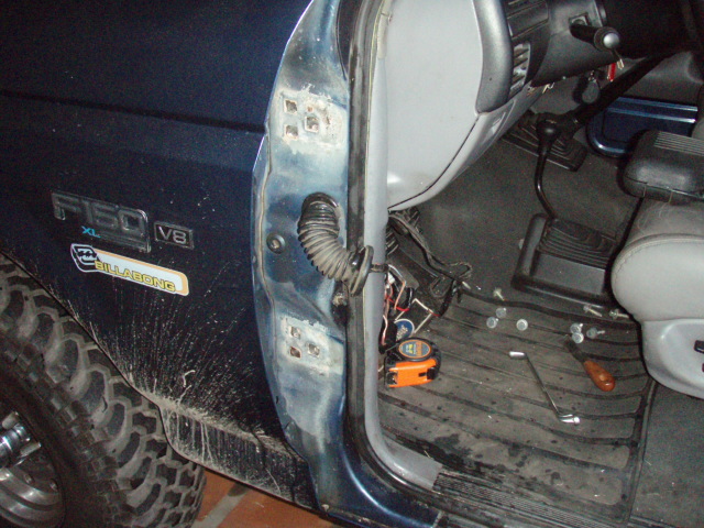 1995 Ford F-150 XL V8 door jamb with visible rust and interior floor mats. Billabong sticker present