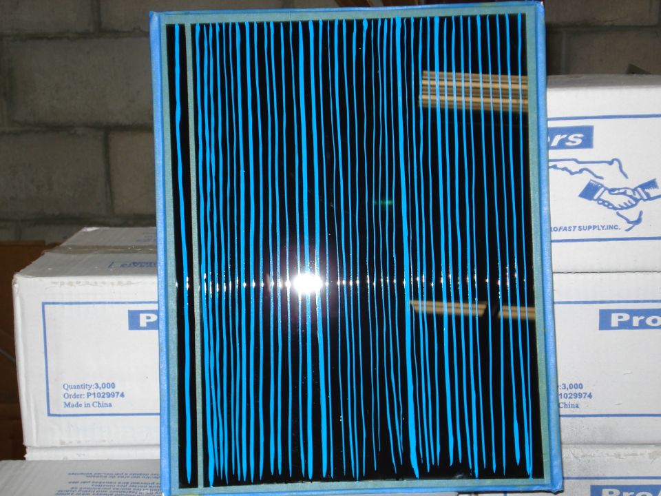 Blue and black striped air filter in front of cardboard boxes
