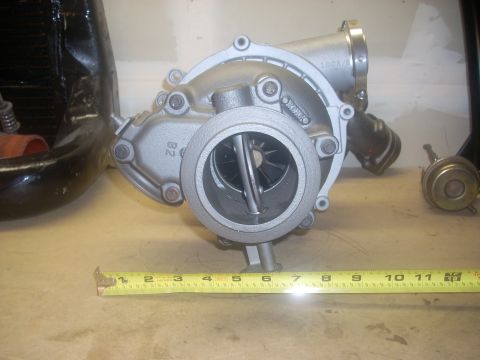 1991 Ford Mustang - Turbocharger and wastegate shown with a measuring tape for scale.
