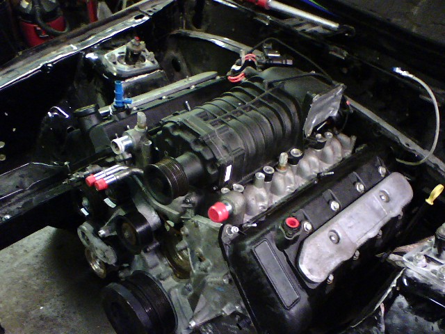 Supercharged V8 engine with black intake manifold and silver valve covers