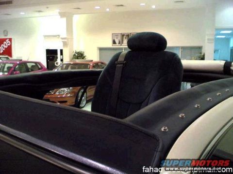 1972 Ford Ranchero - The interior of a car is shown, with other vehicles visible in the background of a showroom.