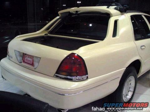 1972 Ford Ranchero - Rear view of a cream-colored sedan an open trunk and a spoiler.