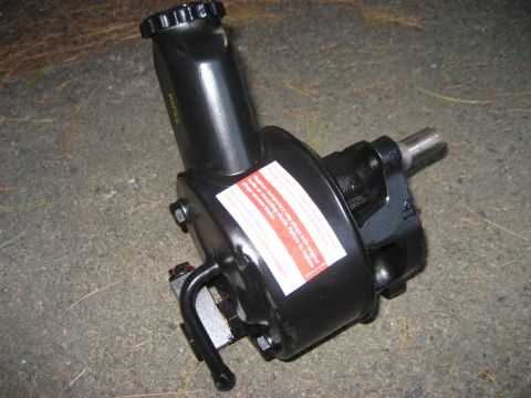 1991 Ford Bronco - A black steering pump is shown, a prominent red and white warning label with text.