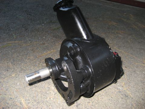 1991 Ford Bronco - A black steering pump is shown resting on a gravelly surface.