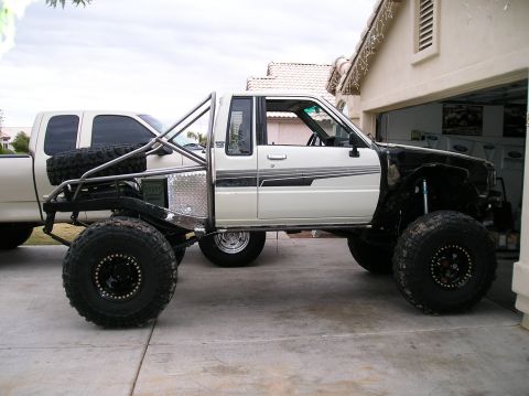 1986 Toyota Hilux - This heavily modified 1986 Toyota Hilux features an extended roll cage and oversized off-road tires.