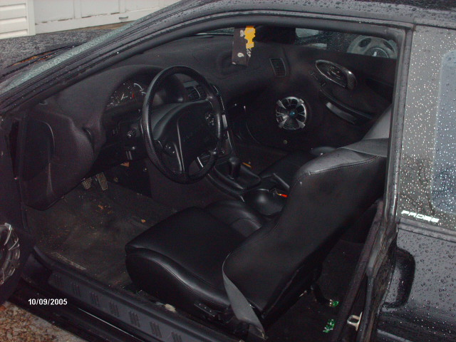 Black interior with leather seats and aftermarket speaker