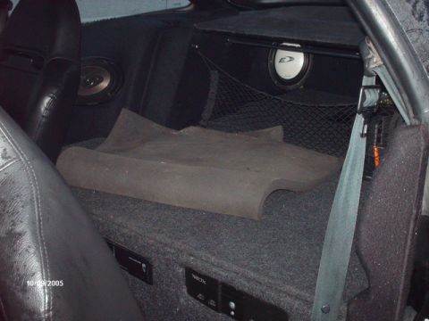 1995 Ford Probe - Custom audio setup in a car interior, a subwoofer box and multiple speakers. Photo dated 10/09/2005.