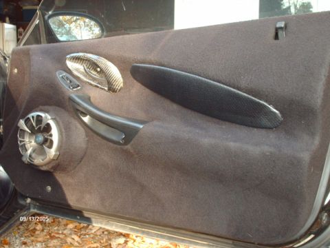 1995 Ford Probe - Interior view of a car door panel, showing custom speaker and door handle.