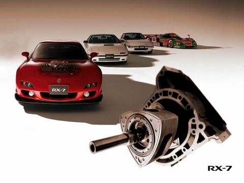 1901 Honda Odyssey - A collection of Mazda RX-7 models and rotary engine components are displayed together.