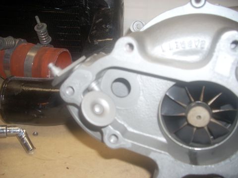 1991 Ford Mustang - Close-up of a turbocharger housing, showing internal components.