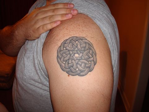 1992 Ford Bronco - A detailed gray celtic knot tattoo is visible on the upper arm of a person wearing a gray t-shirt.