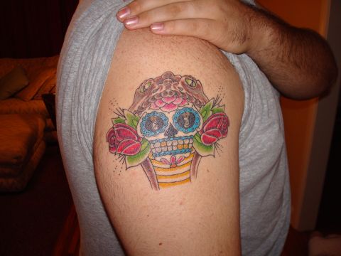 1992 Ford Bronco - Tattoo art a sugar skull, snakes, and roses on an arm.