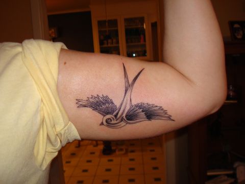 1992 Ford Bronco - A black and grey swallow tattoo is visible on a person's arm.