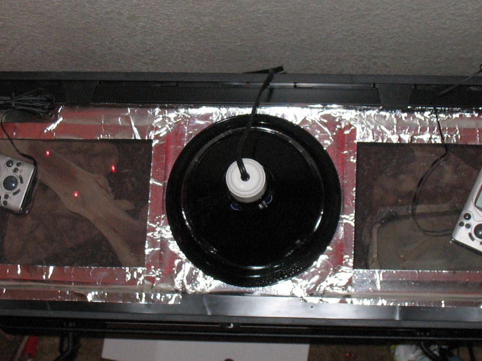 Modified aquarium with turntable, remote controls, and foil lining
