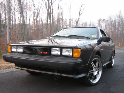 1987 Volkswagen Scirocco - Front view of a black 1987 Volkswagen Scirocco with aftermarket wheels parked outdoors.