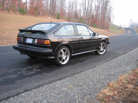 1987 Volkswagen Scirocco - A black Volkswagen Scirocco is seen from the rear quarter angle on a paved road.
